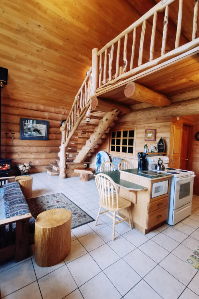 Living dining area with stairs to loft