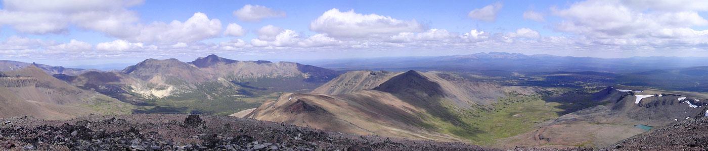 A panoramic view of mountains and a glacier pong.