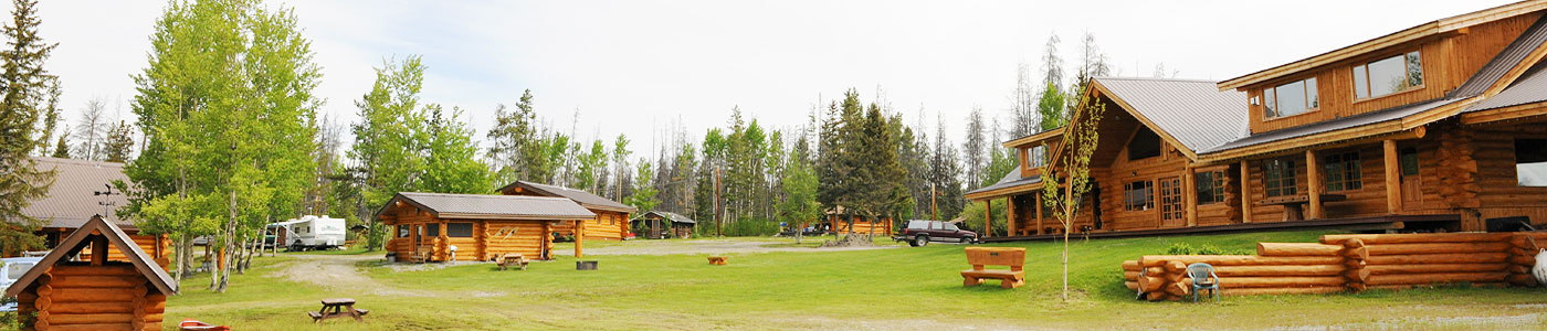 Header Photo of the lodge, several cabins and the lawn