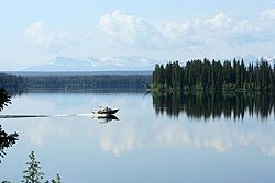 A fast boat speeds across the lake.